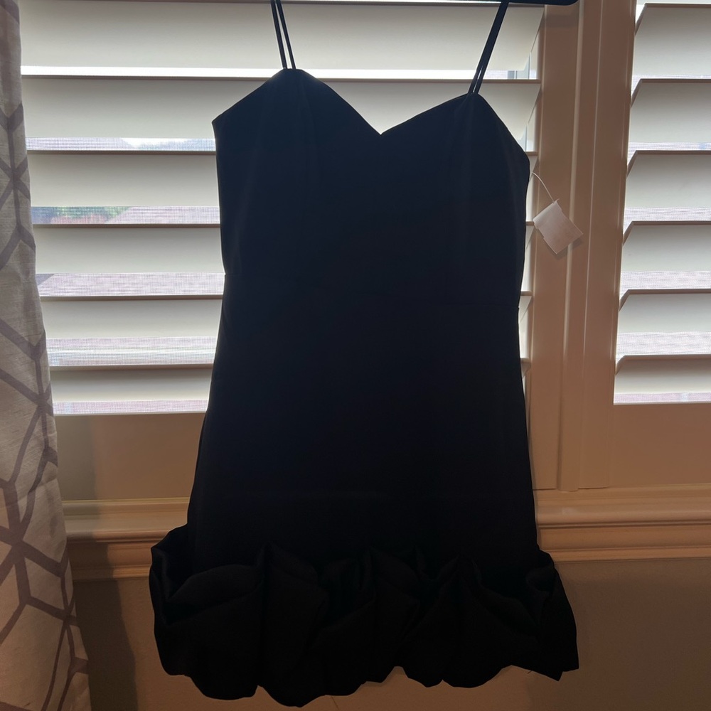 Black sleeveless dress with ruffle at bottom
